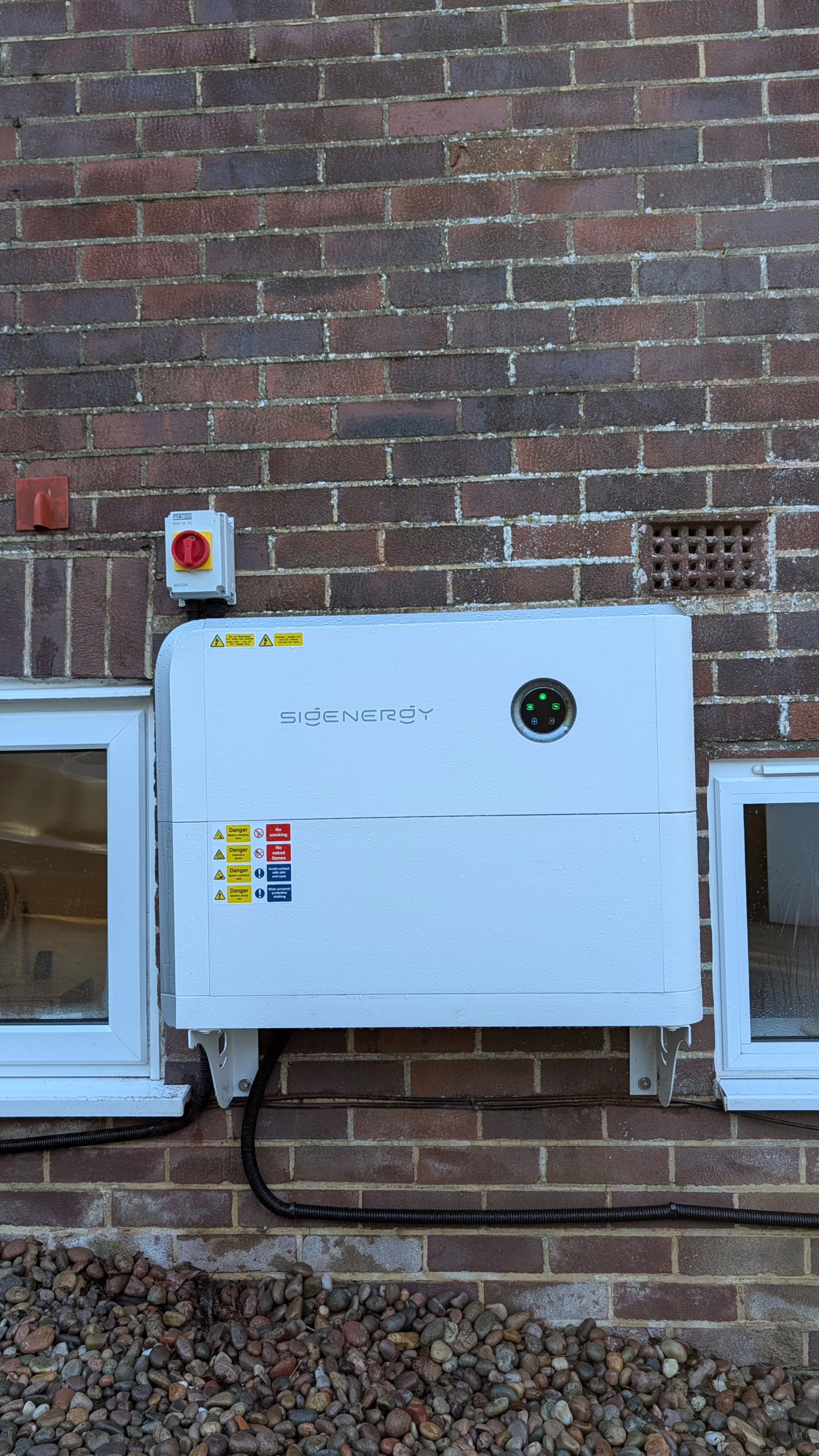 Sigenergy 5-in-1 Energy Storage System installed on brick wall in Poole